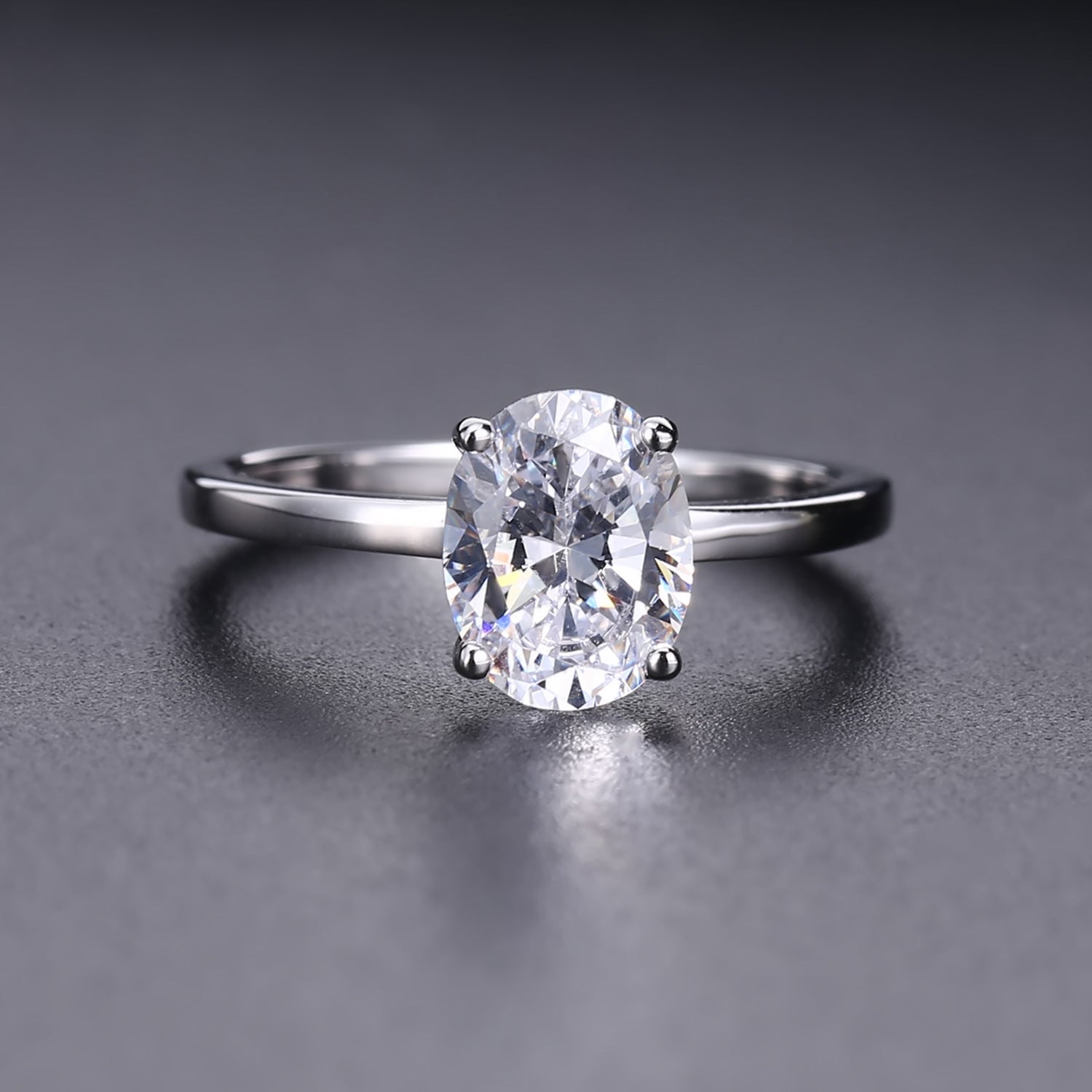 A stunning oval-cut moissanite takes center stage in this simple yet elegant 9ct white gold setting.