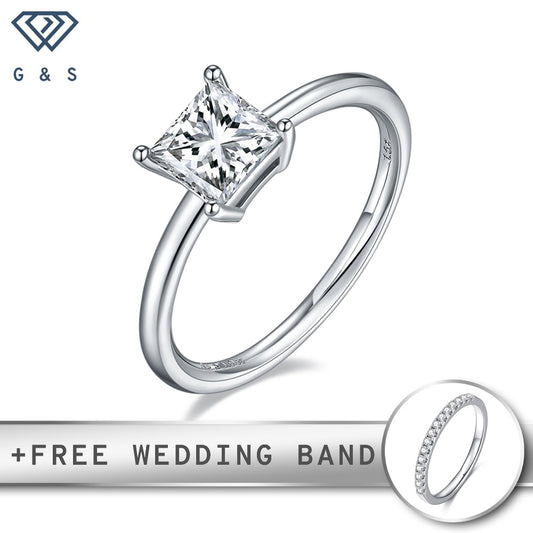 A 1.00ct princess cut moissanite sparkles in a traditional 4-claw setting on a polished sterling silver band.