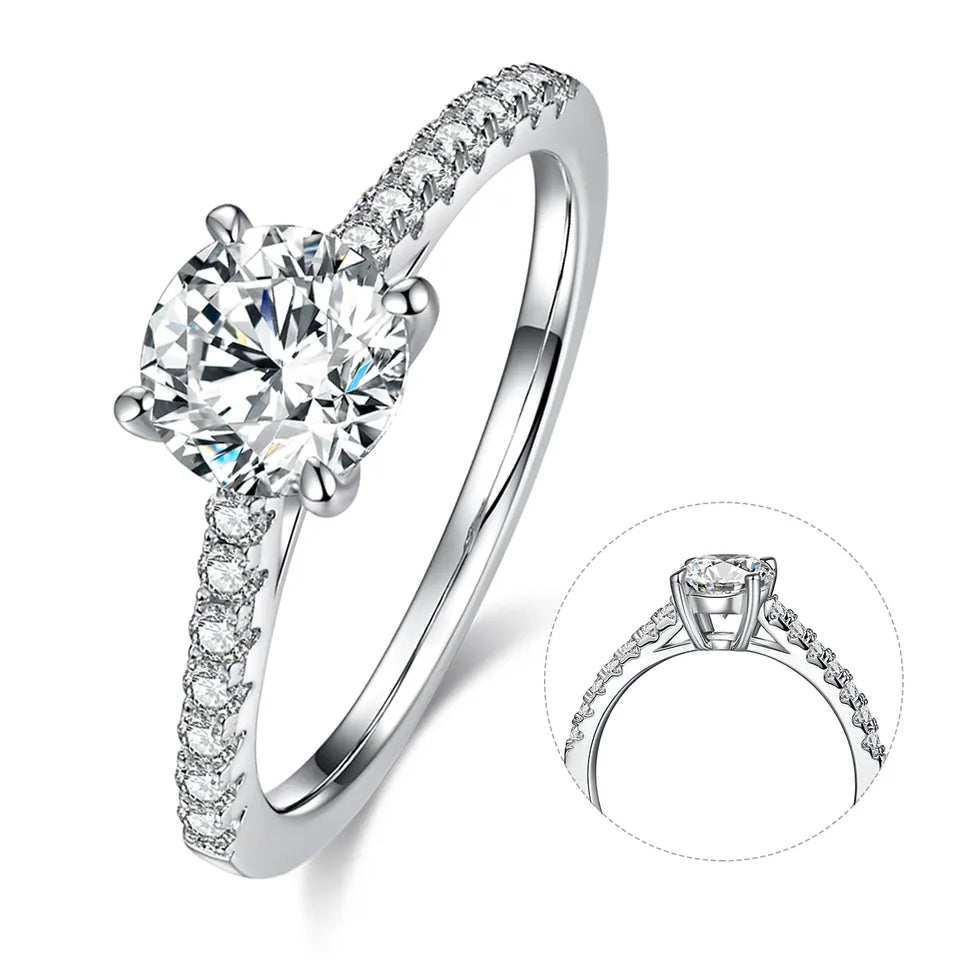 A beautiful and affordable engagement ring crafted from polished sterling silver, highlighting a brilliant 1.00ct round moissanite that captures and reflects light with remarkable fire.