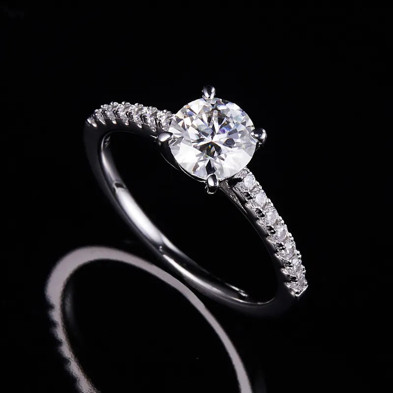 A timeless symbol of love, this ring features a 1.00ct round brilliant moissanite, set in a polished sterling silver band, offering a perfect blend of elegance and affordability.