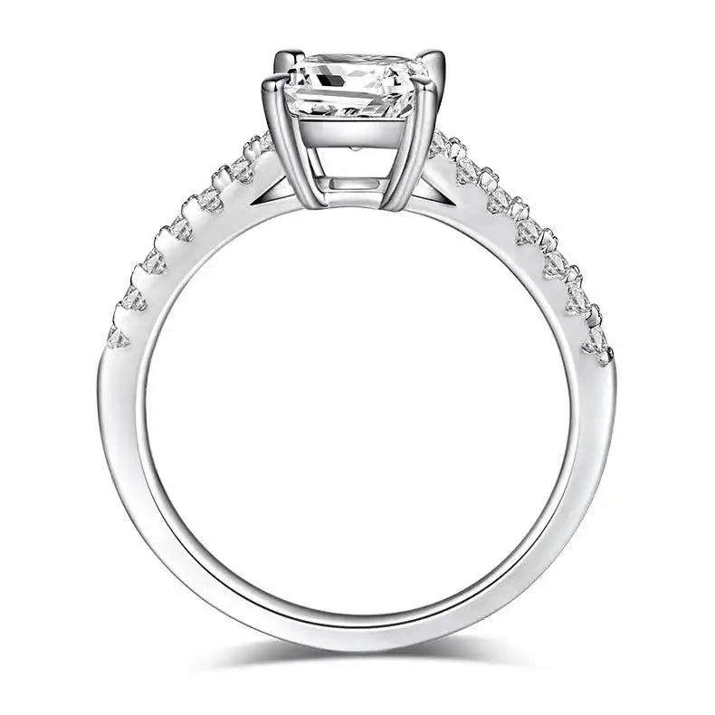  A timeless engagement ring featuring a beautiful princess cut moissanite held in a classic basket setting.