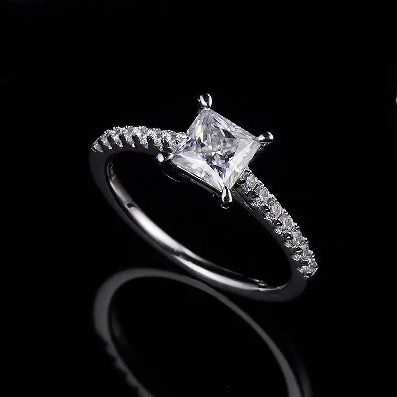A beautifully crafted engagement ring featuring a 1.00ct princess cut moissanite set in a stylish basket setting.