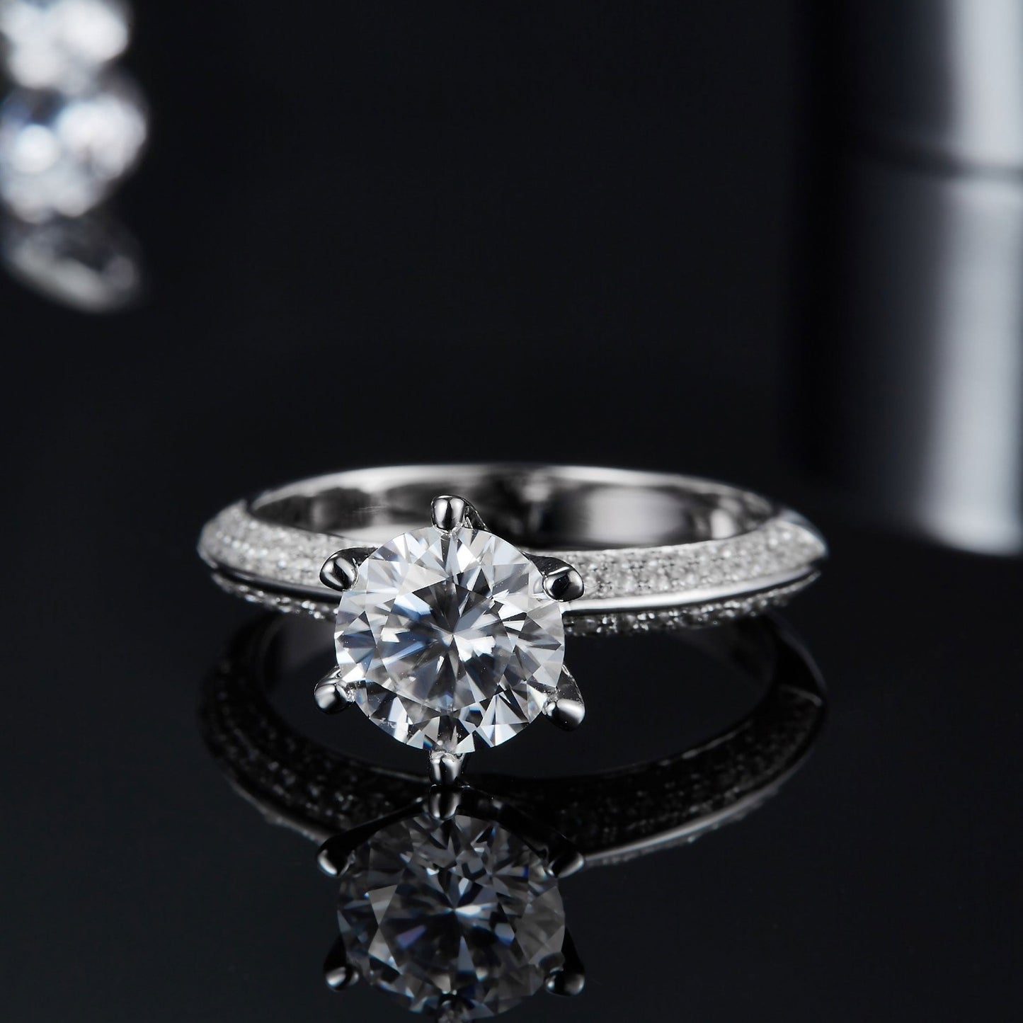 An extreme close-up of the 1.50ct moissanite center stone, demonstrating its clarity and the precision of the pave setting surrounding it.