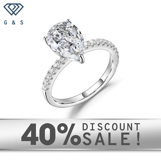 A 1.25ct pear-shaped moissanite takes center stage in this elegant 9ct white gold setting.