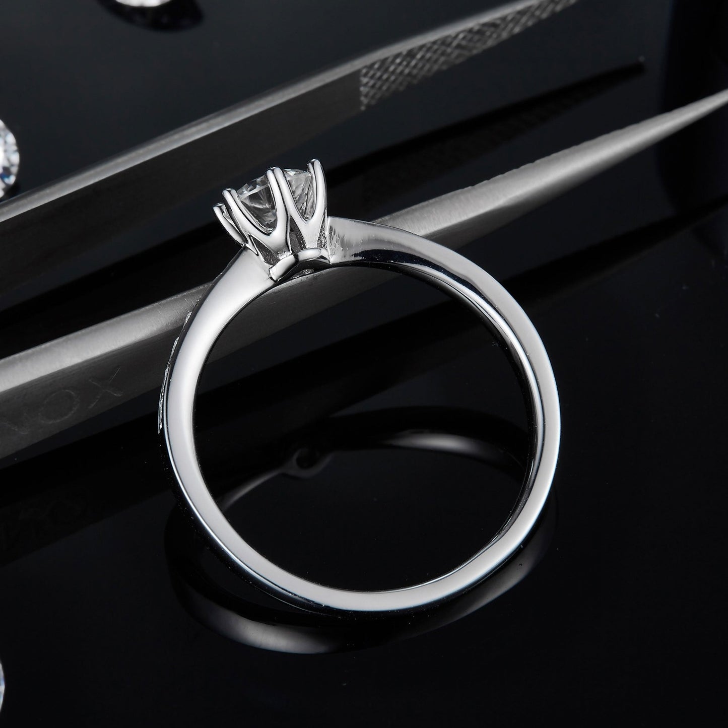 A traditional 6-claw solitaire ring showcasing a 0.50ct moissanite, enhanced by a pave-set band for extra sparkle, all in sterling silver.
