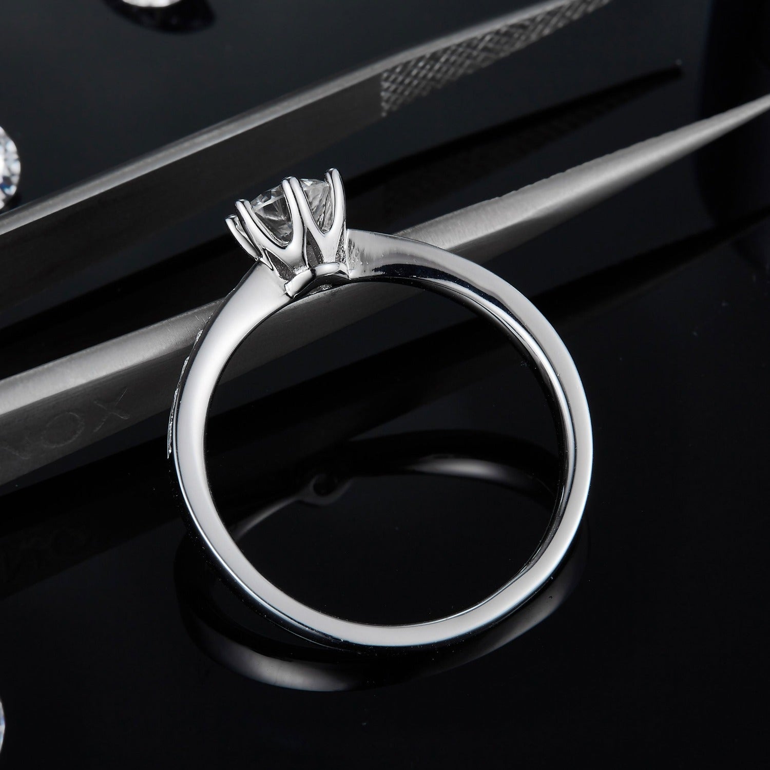 A traditional 6-claw solitaire ring showcasing a 0.50ct moissanite, enhanced by a pave-set band for extra sparkle, all in sterling silver.