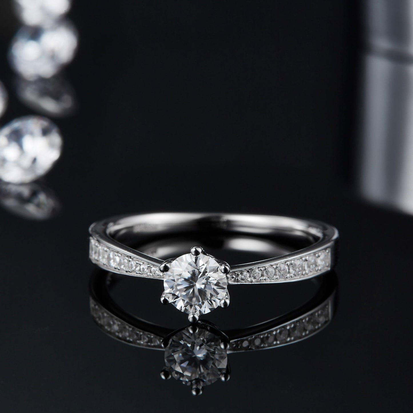 A sterling silver engagement ring combining a classic 6-claw Tiffany setting with a pave-encrusted band for added brilliance.