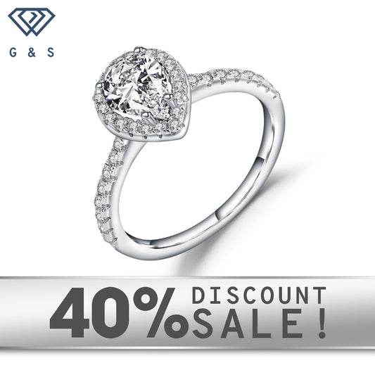 A 1.25ct pear-shaped moissanite sparkles within a delicate halo setting on a 9ct white gold band.