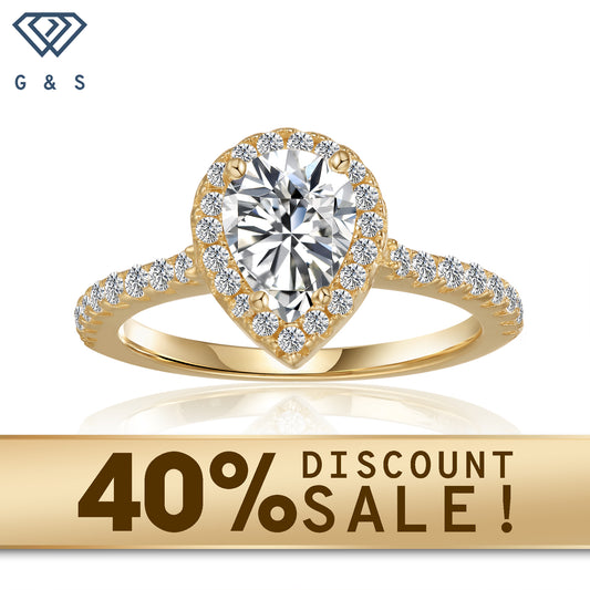 A 1.25ct pear-shaped moissanite sparkles within a delicate halo setting on a warm 9ct yellow gold band.