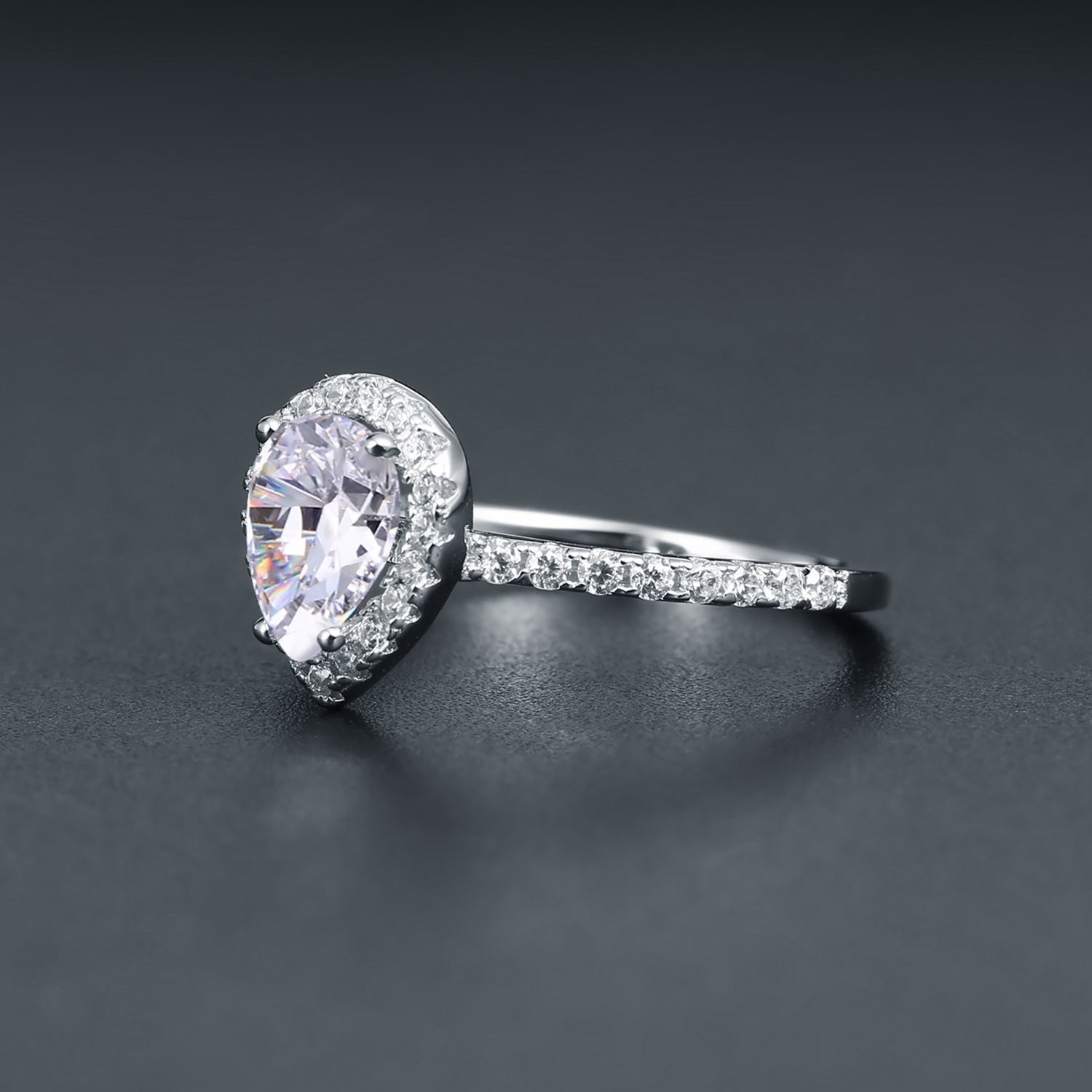 A beautiful engagement ring featuring a 1.25ct pear-shaped moissanite as the focal point, enhanced by a halo setting, crafted in sterling silver.