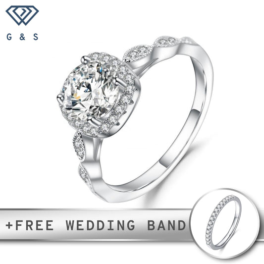 A classic vintage-inspired engagement ring featuring a 1.00ct moissanite center stone surrounded by a delicate halo, set in polished sterling silver.